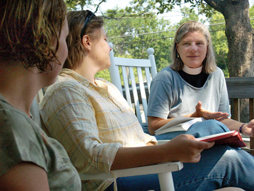 Reverend Lisa Fischbeck, right, discusses passages from the Bible with Alane Kasrawi, far left, and Lauren Kilbourn Gaudett at a relaxed service at The Episcopal Church of the Advocate on Weaver Street Wednesday morning. Photo by Jordan Timpy.