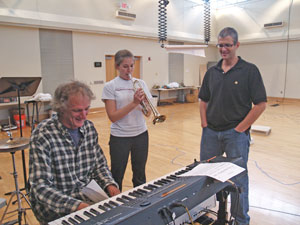 Photo by Kirk Ross. Composer Jack Herrick confers with Playmakers director Joseph Haj and trumpeter Marianne Miller about a tune in Pericles. The play opens next week.