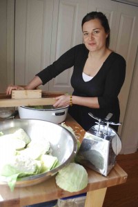 Photo by Ava Barlow. Carrboro resident April McGreger makes sauerkraut in her kitchen by fermenting shredded cabbage with sea salt and juniper berries.